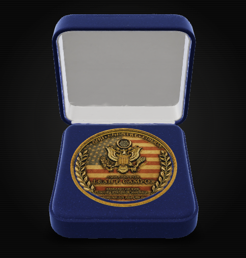 A round commemorative medallion with an American flag design and eagle emblem, displayed inside an open blue presentation box on a black background.