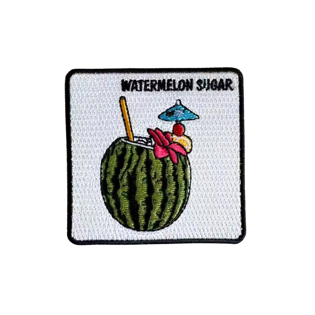 An embroidered square patch featuring a watermelon-themed cocktail labeled 'WATERMELON SUGAR' on a white background with a black stitched border.