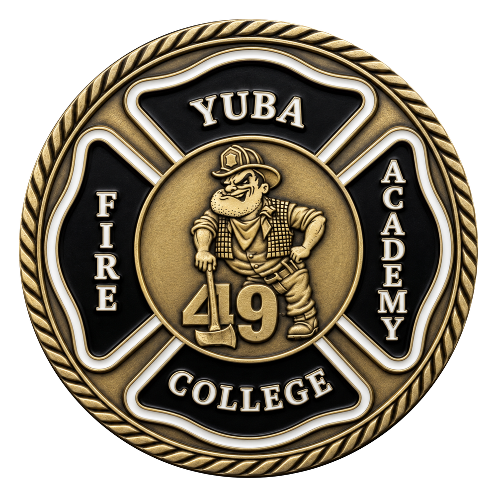 A circular commemorative coin or medallion with a gold-toned and black design. The center shows a firefighter cartoon figure holding an axe with the number 49, surrounded by the words 'YUBA', 'FIRE', 'ACADEMY', and 'COLLEGE' on a Maltese cross shape, with a rope border around the edge.