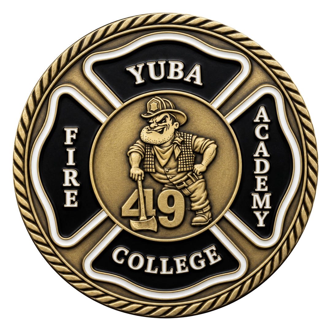 A circular commemorative coin or medallion with a gold-toned and black design. The center shows a firefighter cartoon figure holding an axe with the number 49, surrounded by the words 'YUBA', 'FIRE', 'ACADEMY', and 'COLLEGE' on a Maltese cross shape, with a rope border around the edge.