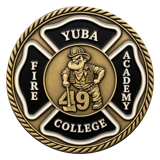 A circular commemorative coin or medallion with a gold-toned and black design. The center shows a firefighter cartoon figure holding an axe with the number 49, surrounded by the words 'YUBA', 'FIRE', 'ACADEMY', and 'COLLEGE' on a Maltese cross shape, with a rope border around the edge.
