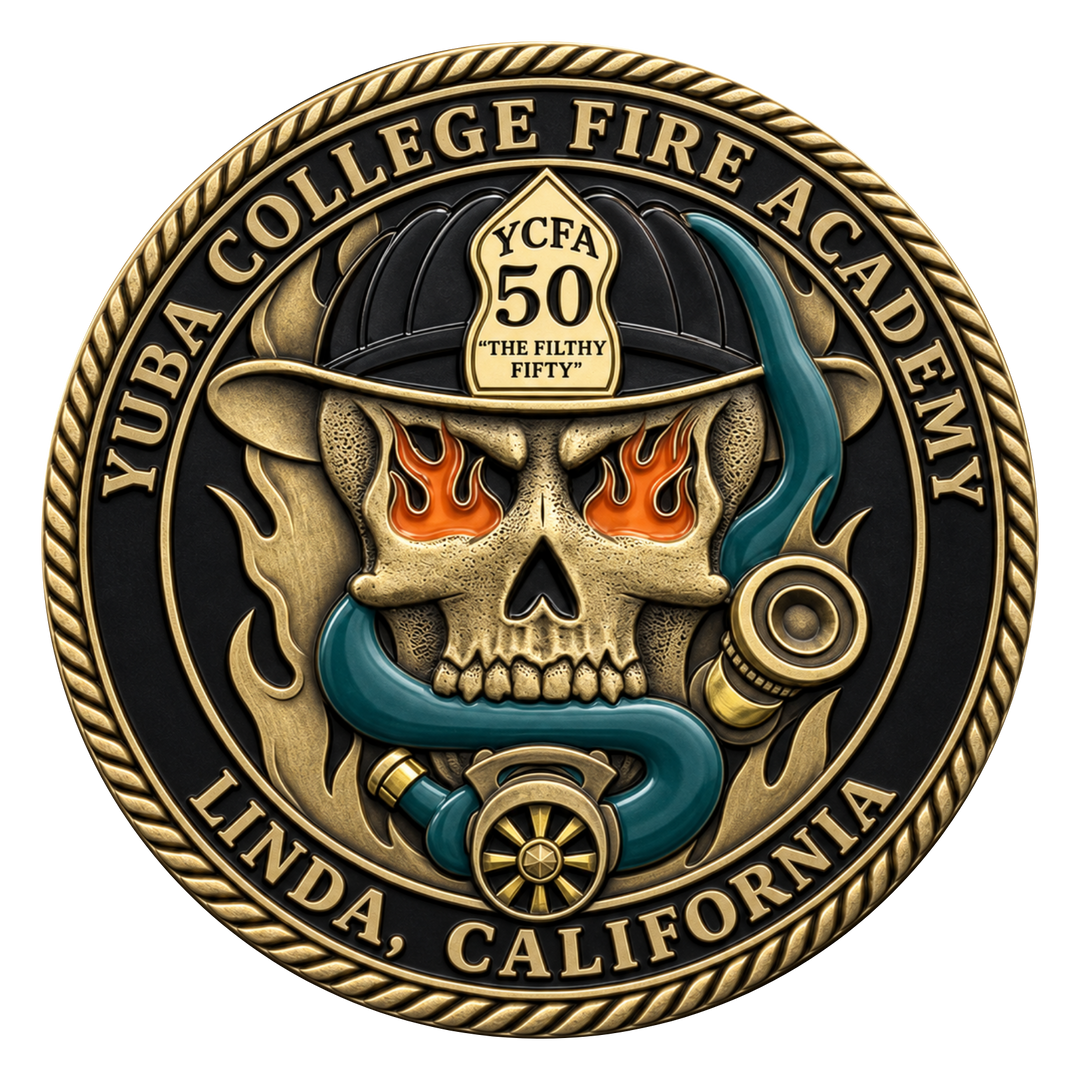 A circular commemorative fire academy medallion or coin featuring a skull wearing a firefighter helmet, with flames in the eye sockets, a blue snake, and gold-toned text reading 'YUBA COLLEGE FIRE ACADEMY' and 'LINDA, CALIFORNIA.' The design is shown on a plain white background.