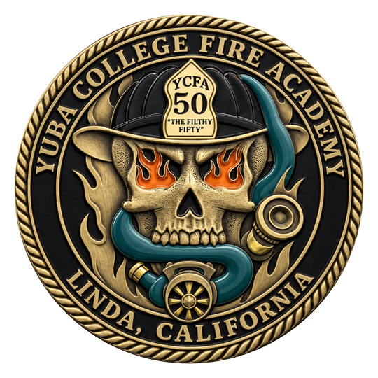 A circular commemorative fire academy medallion or coin featuring a skull wearing a firefighter helmet, with flames in the eye sockets, a blue snake, and gold-toned text reading 'YUBA COLLEGE FIRE ACADEMY' and 'LINDA, CALIFORNIA.' The design is shown on a plain white background.